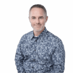 Ryan Soper-Powell, CX Friction Hunter, facing camera wearing blue patterned shirt. Headshot against clear white background.